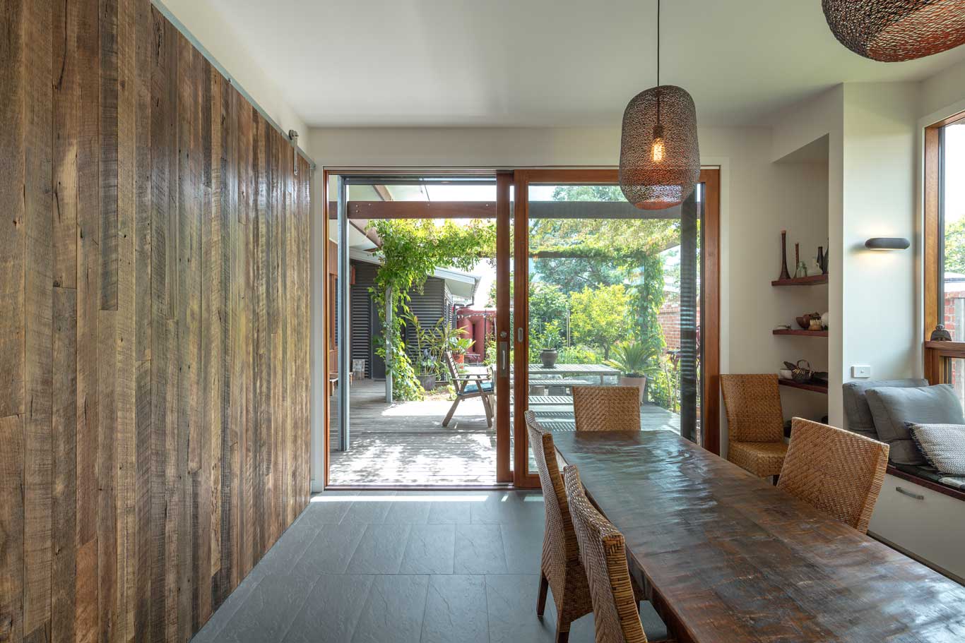 dining room with large windows towards backyard